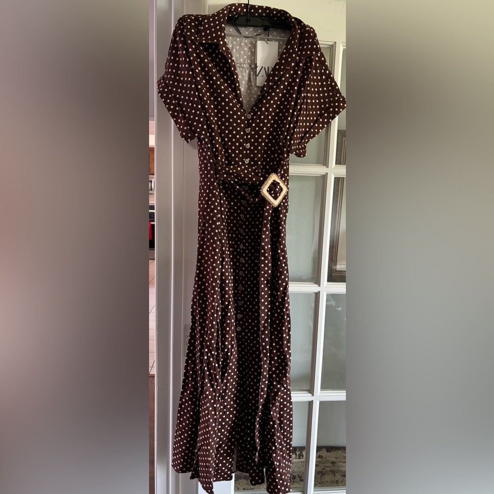 Brown and white polka dot wrap dress with belt.
